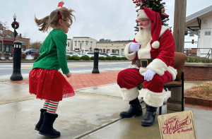 Image Little Girl Jumping in Excitement to See Santa at Depot Park