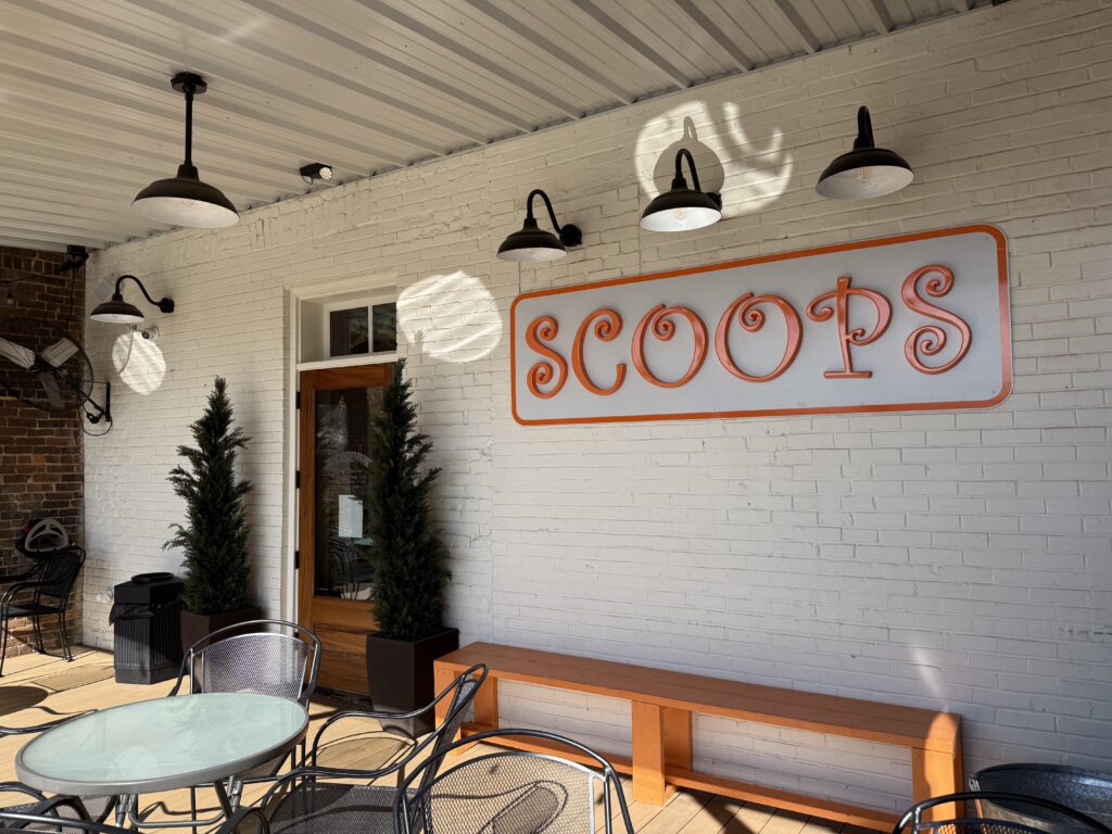 Outdoor patio of a café with a sign reading 