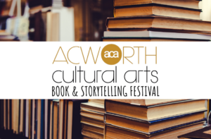 A stack of books in a library with a banner reading “Acworth Cultural Arts Book & Storytelling Festival” across the center.