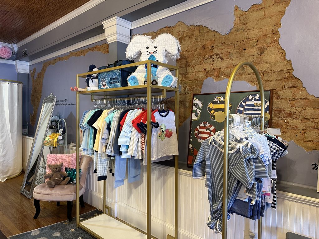Image Interior of Bows and Ties Children's Boutique in Historic Downtown Acworth Featuring Children's Clothing.