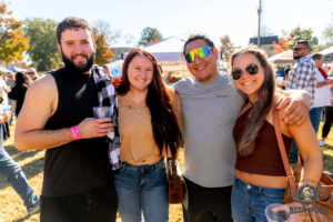 Four people at the park smiling for a photo