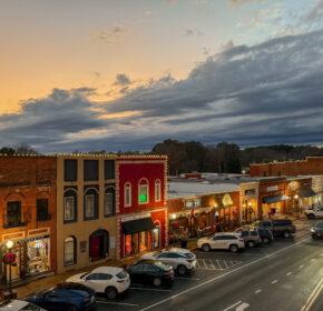 As the sun sets on Acworth's small-town main street, the illuminated storefronts invite you in, offering warmth against the cloudy sky. With parked cars lining the street, pop in and discover 6 Winter Combos for Fresh Food + a Good Mood to brighten your evening.