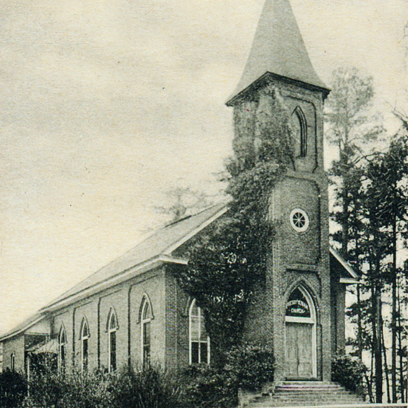 A black and white photo of a brick church with arched windows, a tall steeple, and ivy-covered front, surrounded by trees. Learn more about historic Acworth locations captured in timeless detail. A black and white photo of a brick church with arched windows, a tall steeple, and ivy-covered front, surrounded by trees. Learn more about historic Acworth locations captured in timeless detail.