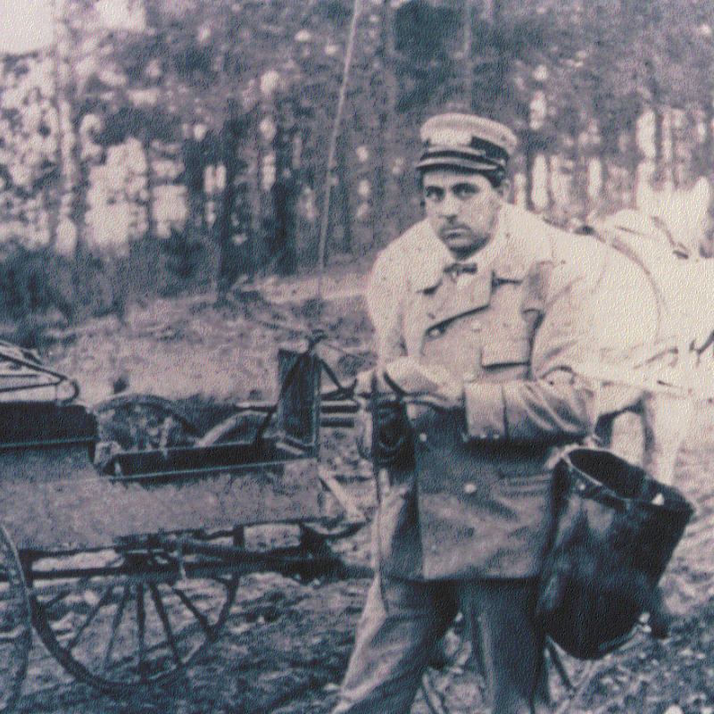 A man in an old-fashioned uniform stands beside a horse-drawn mail cart in a rural, wooded area—Learn More About Historic Acworth Locations as you step back in time. A man in an old-fashioned uniform stands beside a horse-drawn mail cart in a rural, wooded area—Learn More About Historic Acworth Locations as you step back in time.