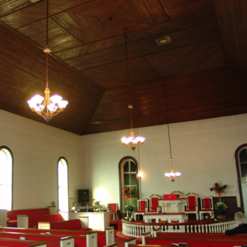 Interior of a church with wooden ceiling, chandeliers, red pews, arched windows, and a pulpit at the front. Learn More About Historic Acworth Locations as you explore this beautifully preserved sanctuary. Interior of a church with wooden ceiling, chandeliers, red pews, arched windows, and a pulpit at the front. Learn More About Historic Acworth Locations as you explore this beautifully preserved sanctuary.