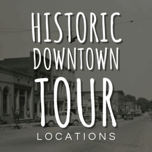 Black-and-white photo of a small town street with older buildings and vintage cars, overlaid with text reading "Historic Downtown Tour Locations.
