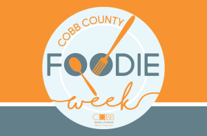 Circular logo for Cobb County Foodie Week, featuring a fork and spoon as part of a plate design, with orange, gray, and white color scheme. Cobb Travel & Tourism logo at the bottom.