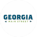 Logo with the word "GEORGIA" in bold blue letters above the words "MAIN STREET" in smaller green letters, all on a white circular background.