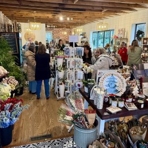 Customers browse and shop among flowers, gifts, and cards in a bright, busy boutique store with wooden floors and exposed beams—plus discover 6 Winter Combos for Fresh Food + a Good Mood in Acworth.