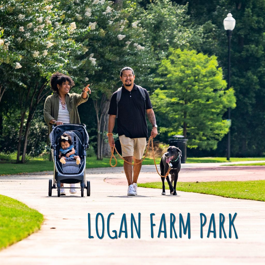 Image Family walking with stroller and dog through Logan Farm Park with woman pointing to the distance
