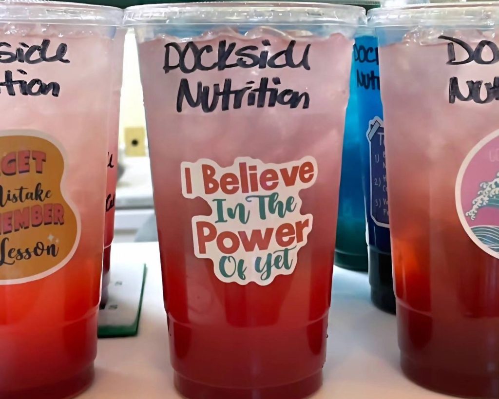 A clear plastic cup labeled 