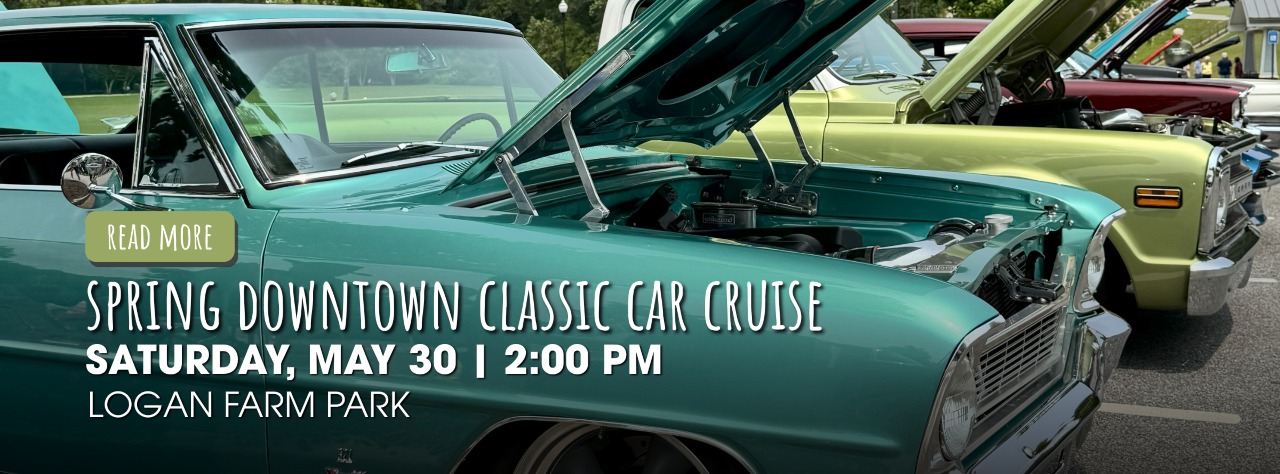 Several classic cars with open hoods are parked in a row at an outdoor car show; event details for a Spring Downtown Classic Car Cruise overlay the image.