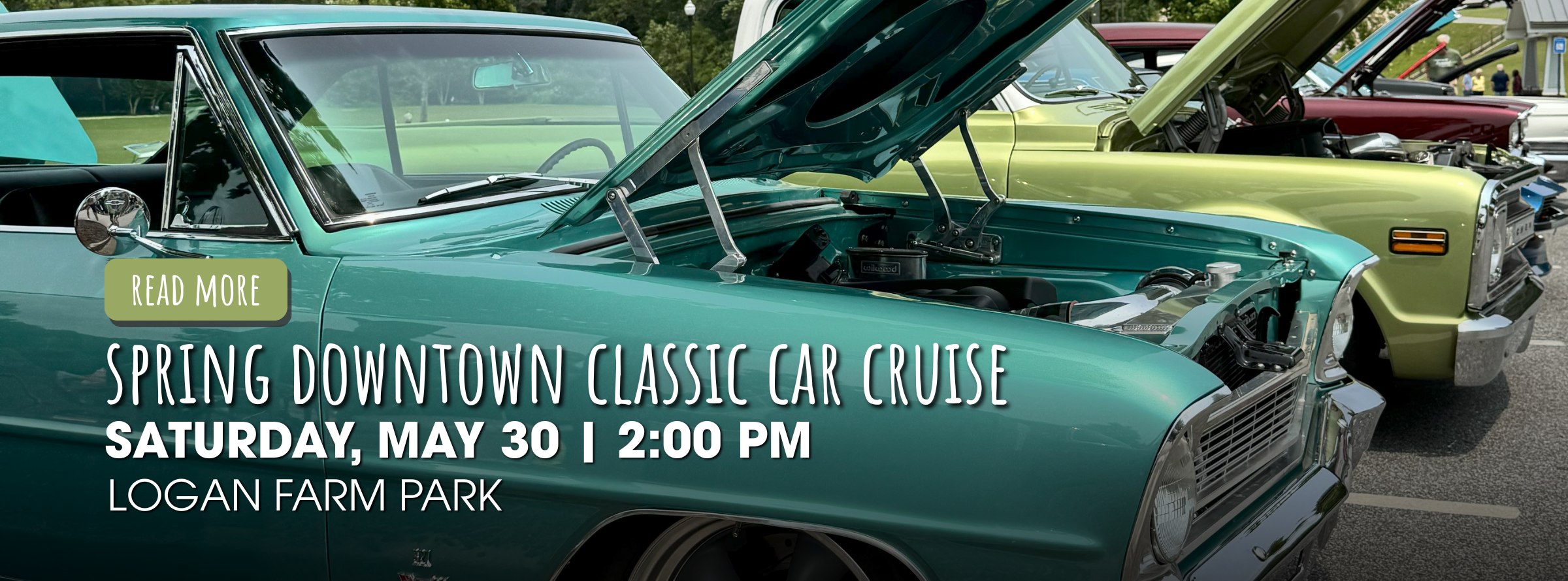 A row of classic cars with open hoods is parked in a lot, promoting the Spring Downtown Classic Car Cruise event on Saturday, May 30 at 2:00 PM at Logan Farm Park.